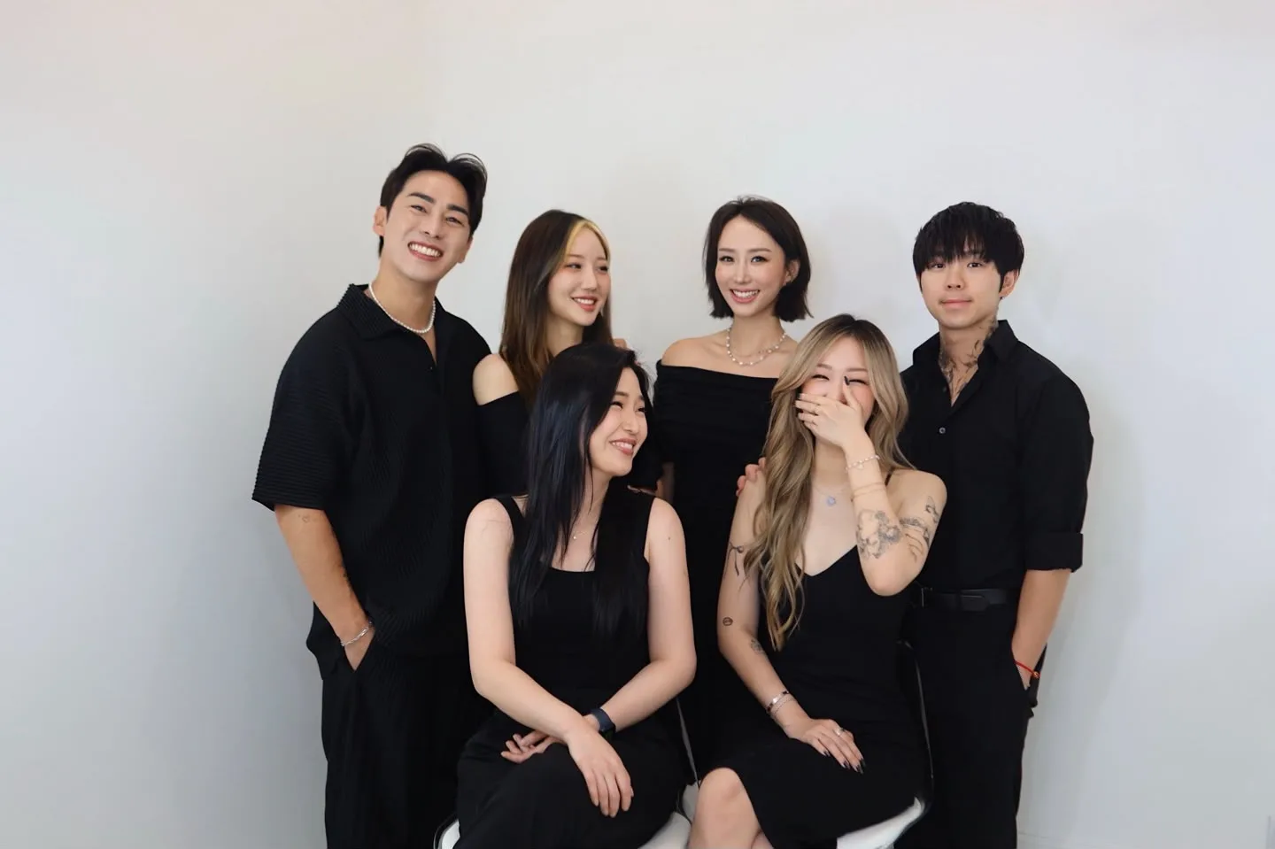 The Shabang Beauty team of six PMU artists, dressed in black against a bright studio wall
